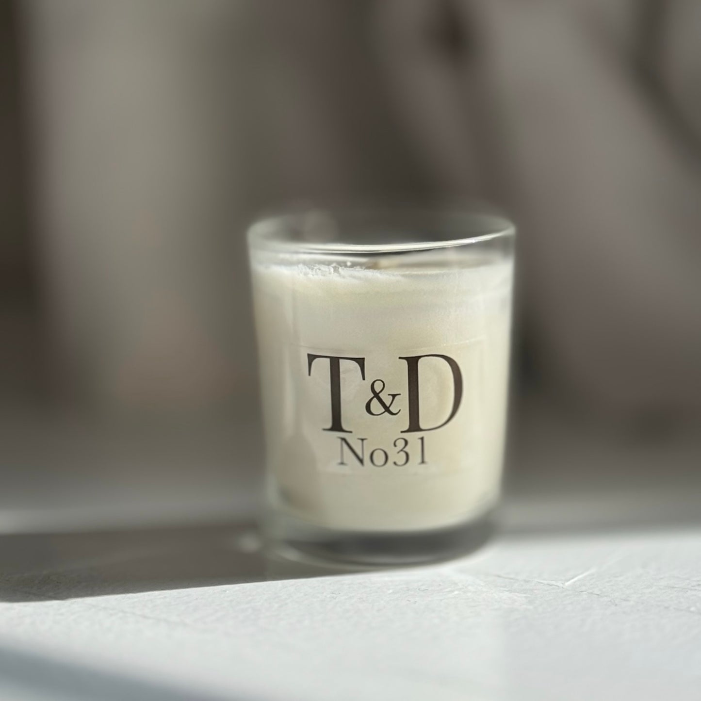 clear glass votive with clear label logo