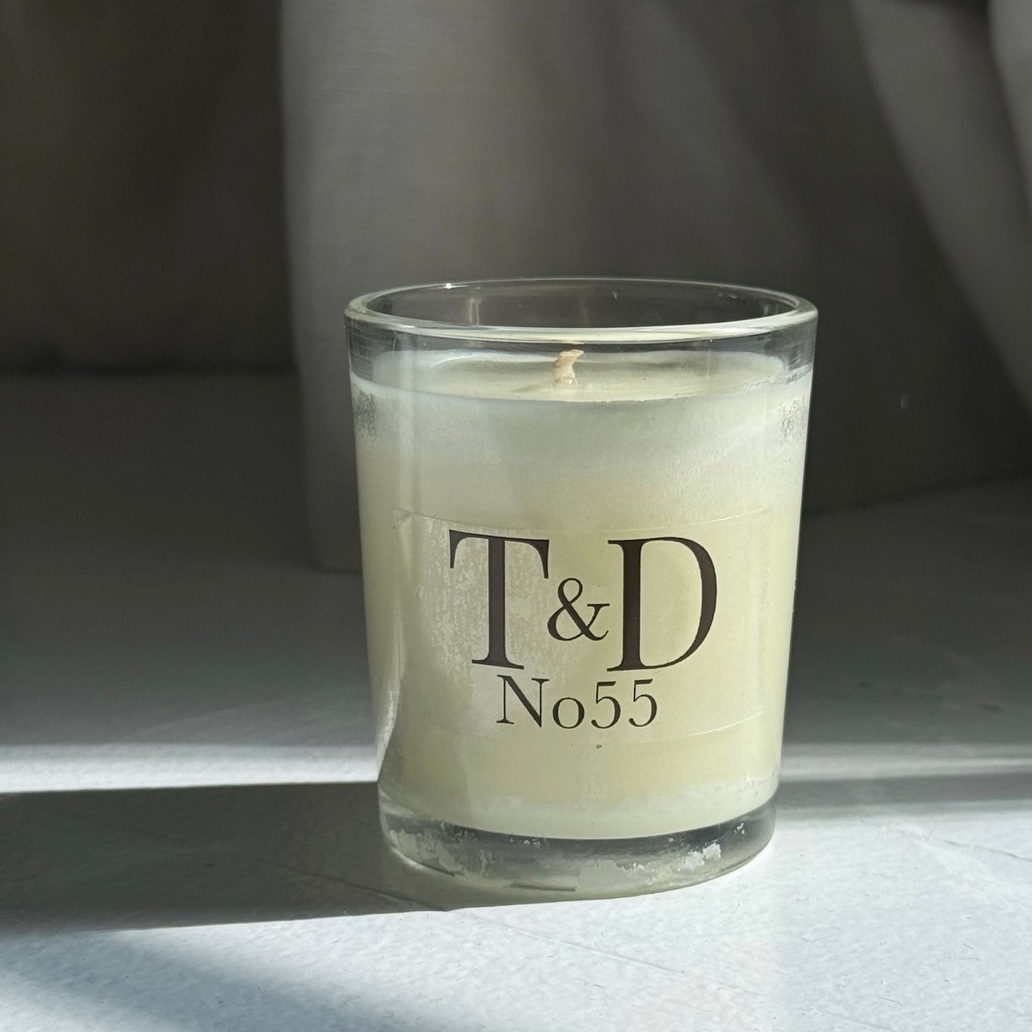 clear glass votive with clear label logo
