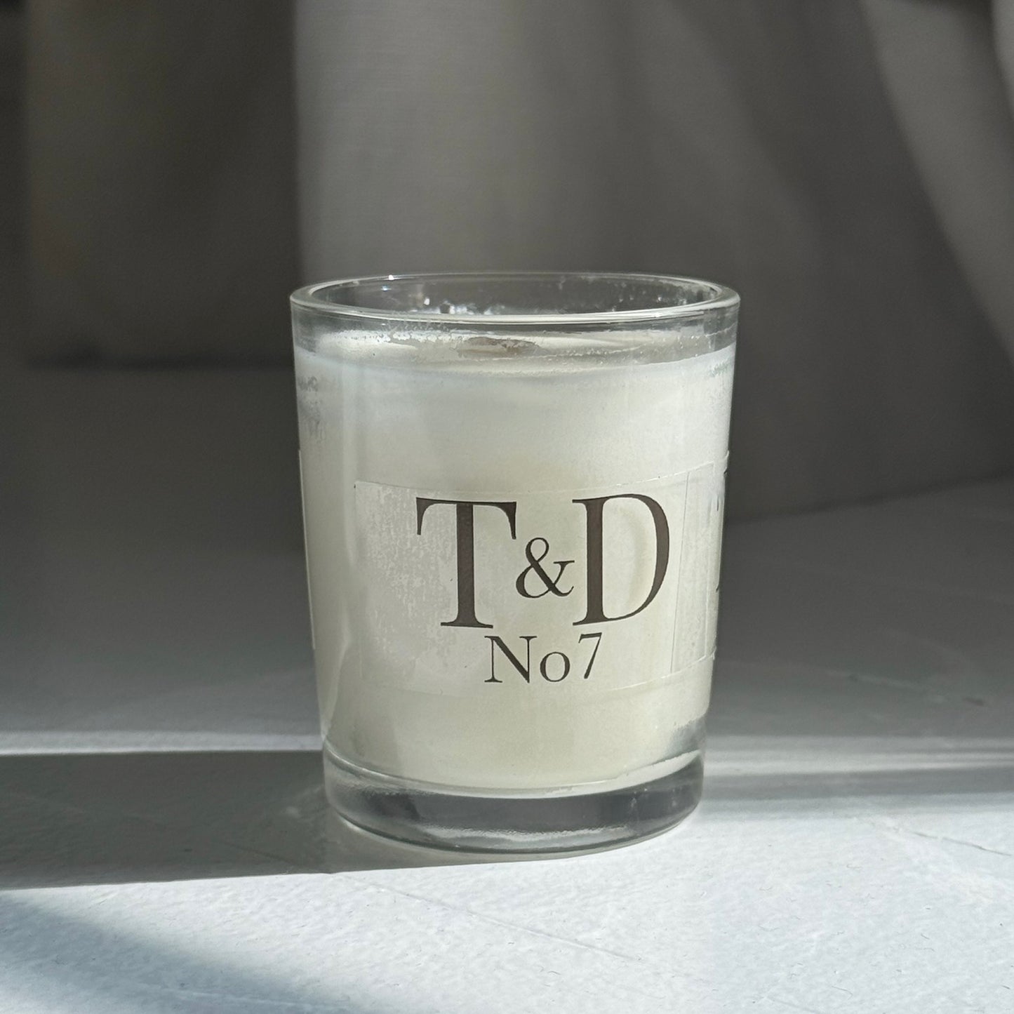 clear glass votive with clear label logo