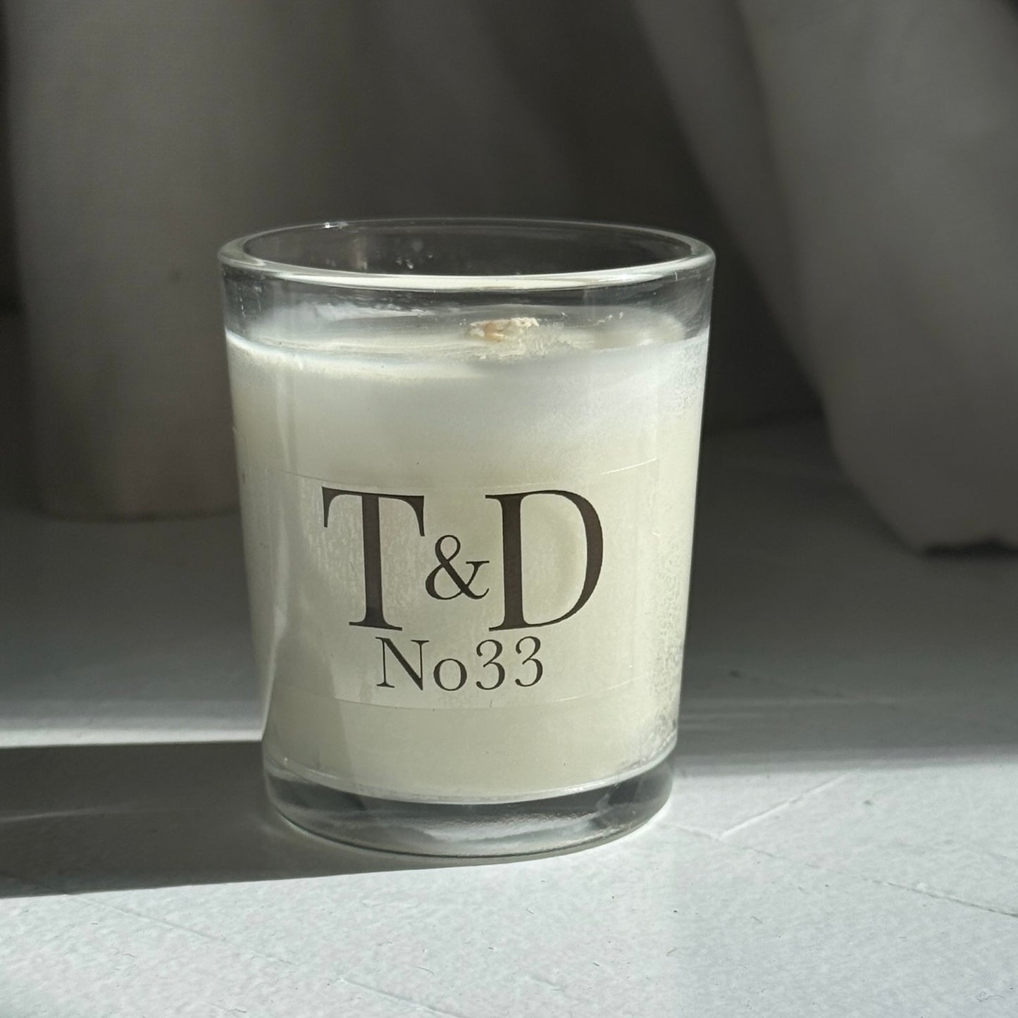 clear glass votive with clear label logo