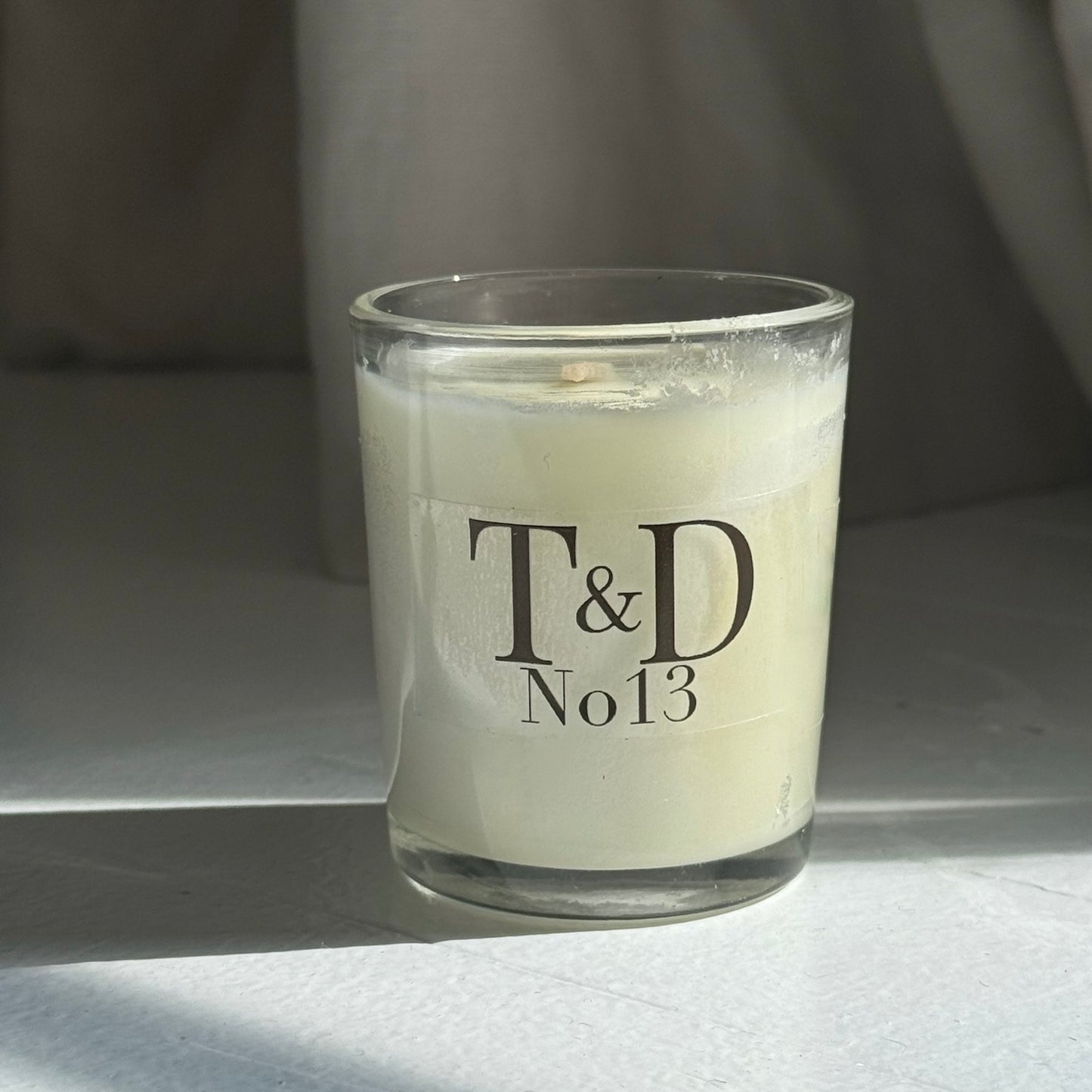 clear glass votive with clear label logo