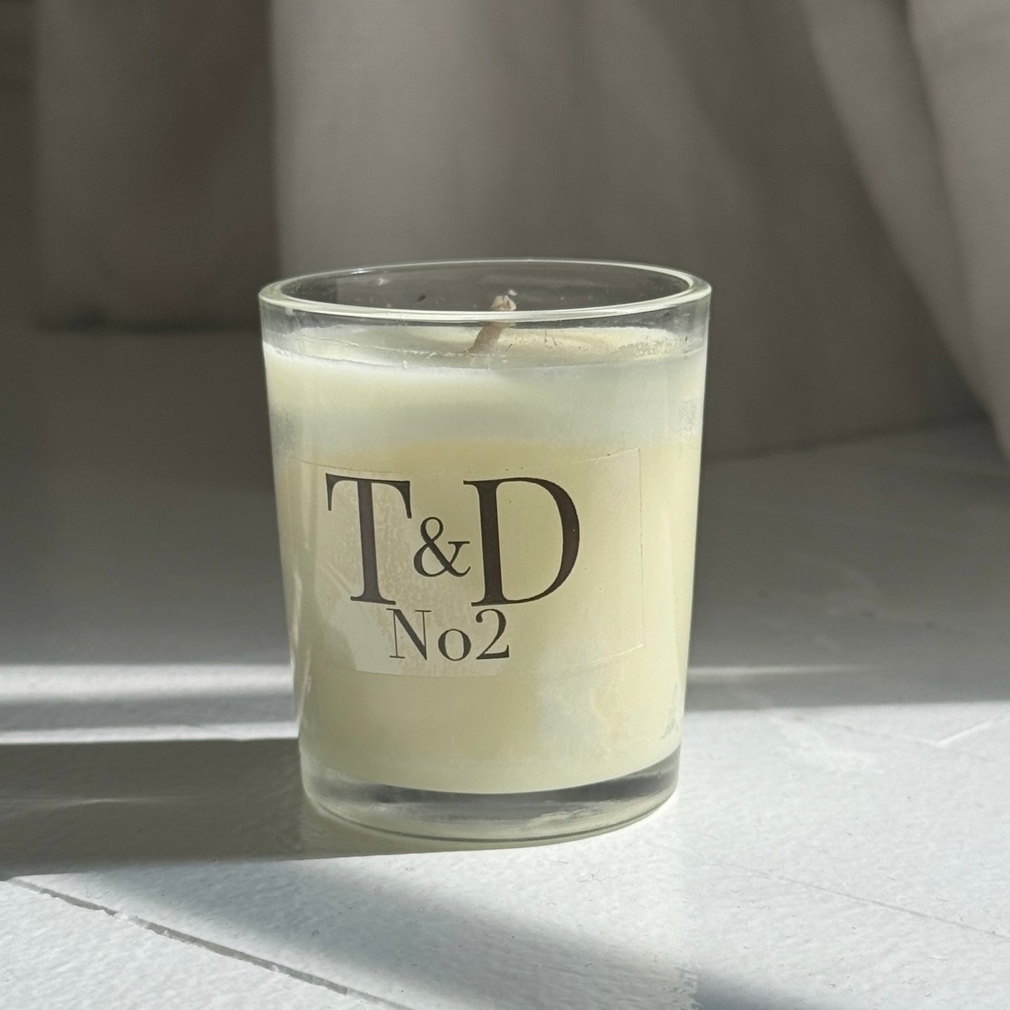 clear glass votive with clear label logo