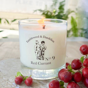 red currant scented candle in clear glass with black logo