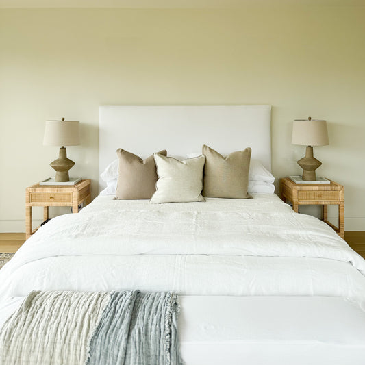 Upholstered bed with white fabric