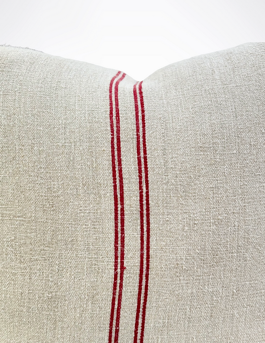 Close-up of a beige fabric with red stripes on a white background