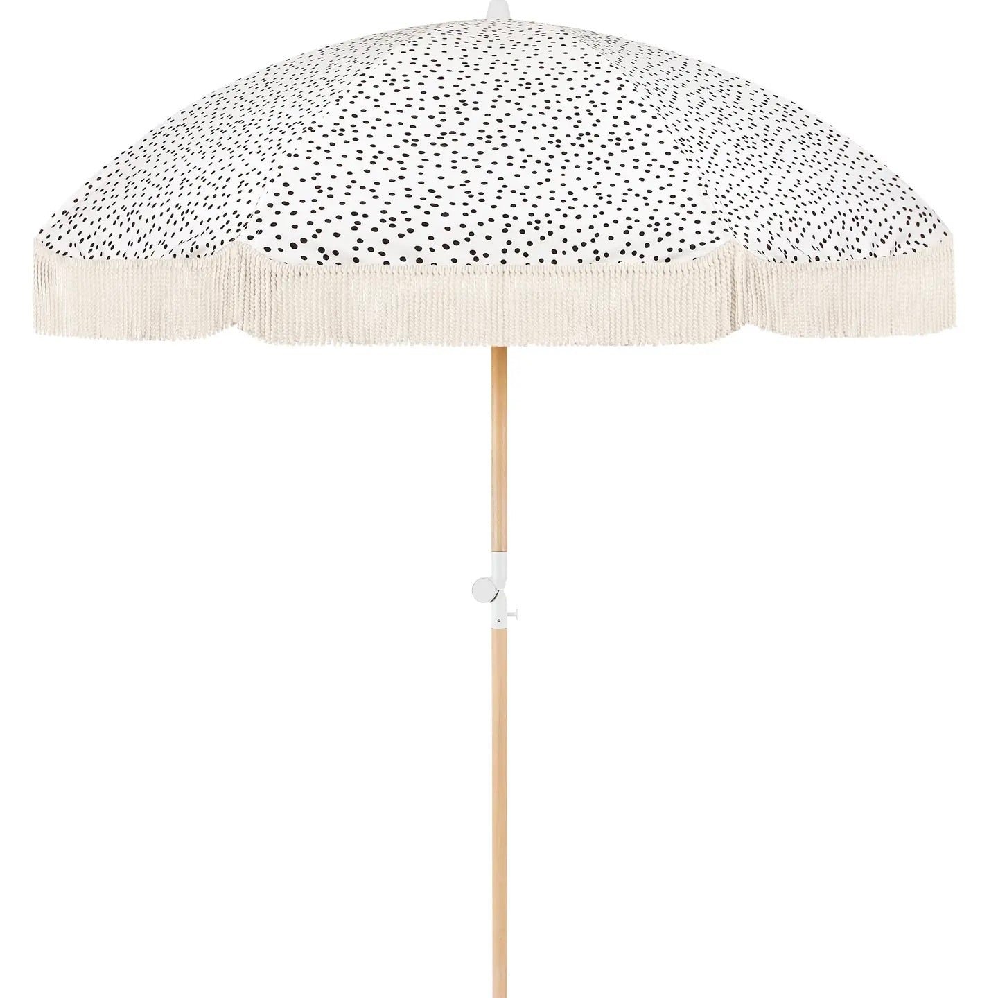 A beige and white dotted beach umbrella with a wooden pole and a fringe detail on the edges.