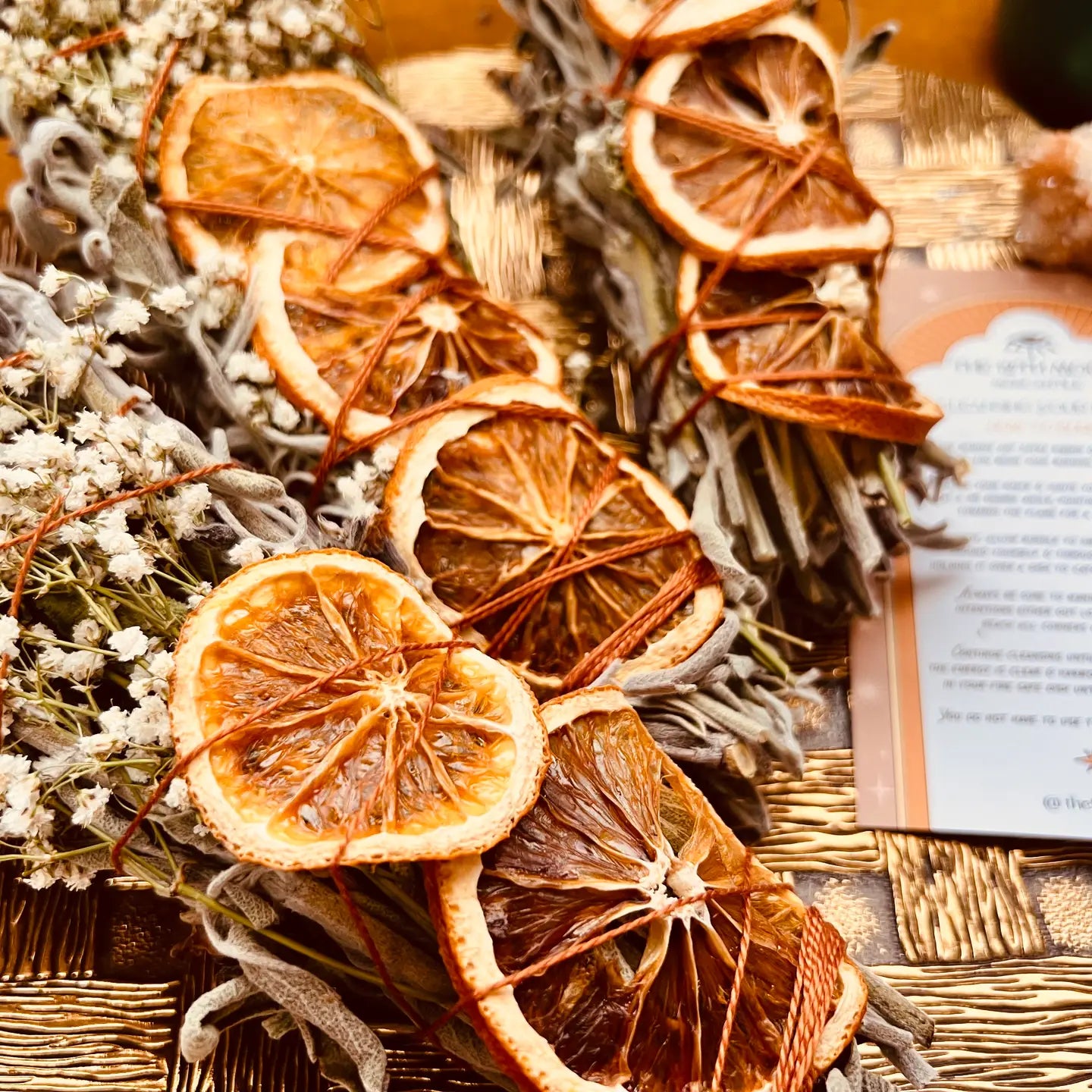 sage bundles with dried orange slices and baby's breath
