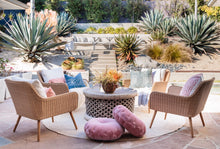 Load image into Gallery viewer, outdoor patio area with rattan chairs, wooden round coffee table, purple floor cushions and large cactus landscaping