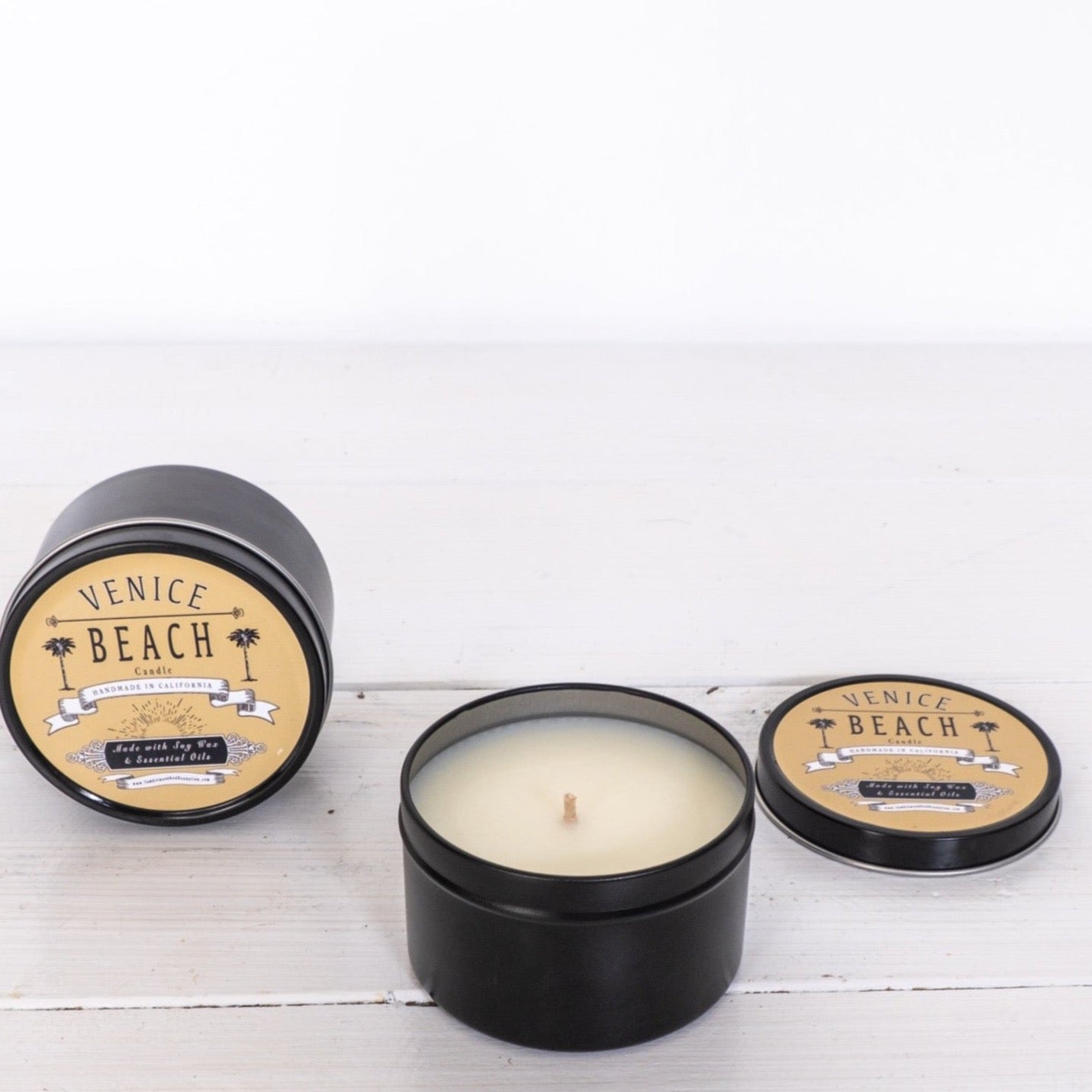 Black travel candle tin with Venice Beach logo on lid
