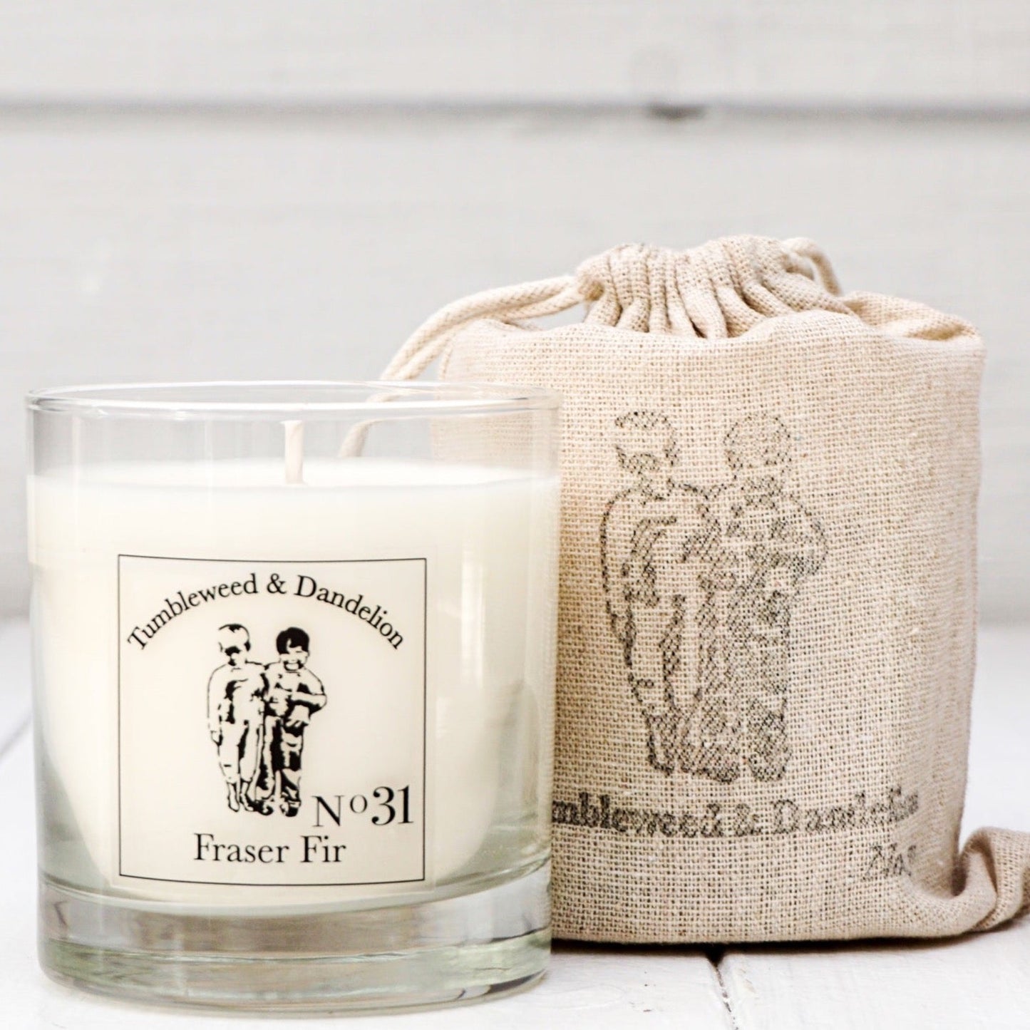 Fraser Fir scented clear glass candle with black logo