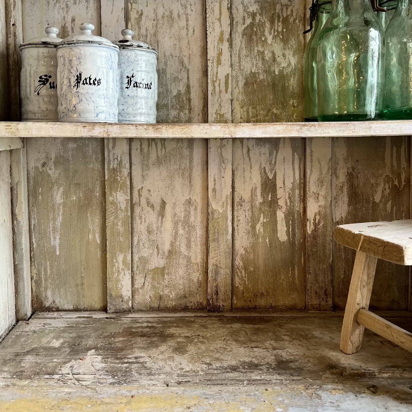 rustic hutch of old wood with distressed butter yellow paint finish, glass doors on top and bottom