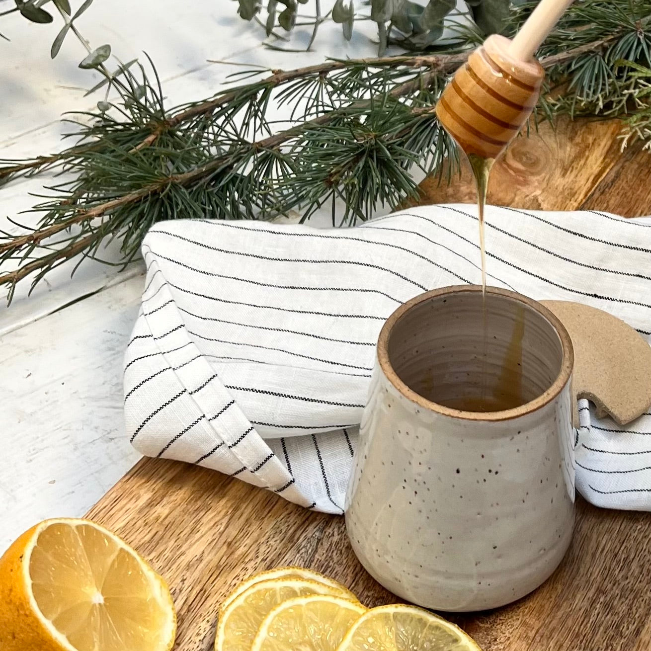 ceramic jar with lid and wooden honey dipper