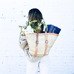 wicker basket that is also a backpack with leather handles and straps