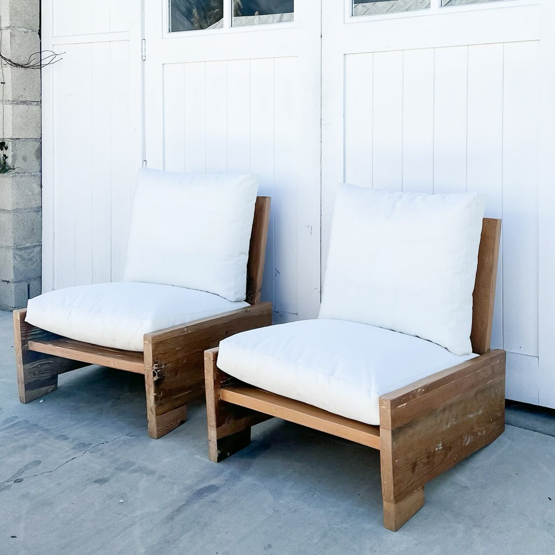 wood outdoor armless lounge chair with white cushions