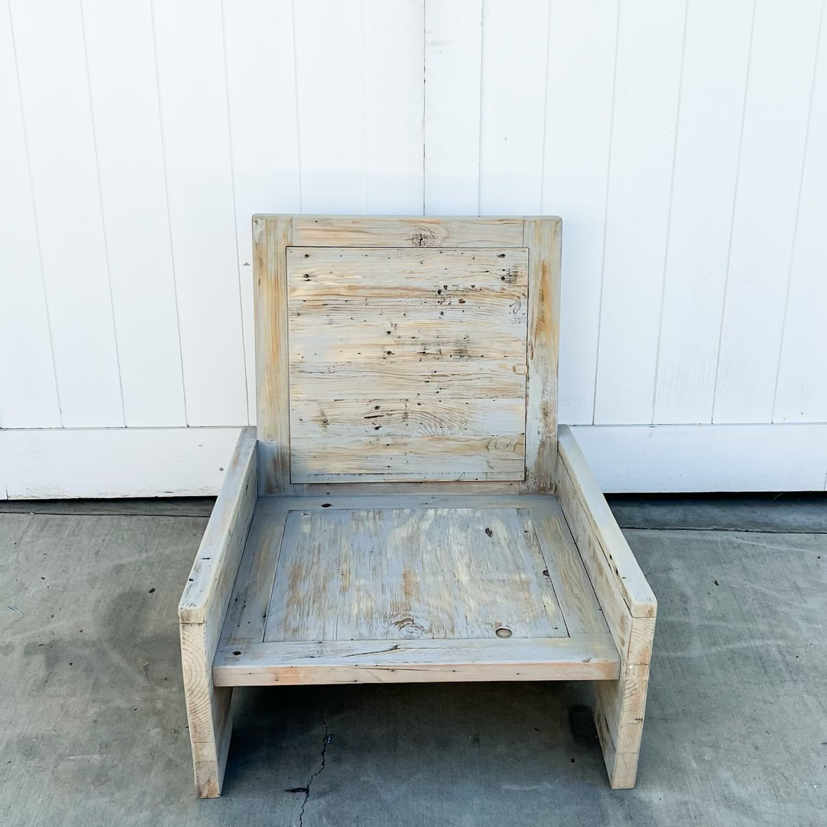 wood outdoor armless lounge chair with white cushions