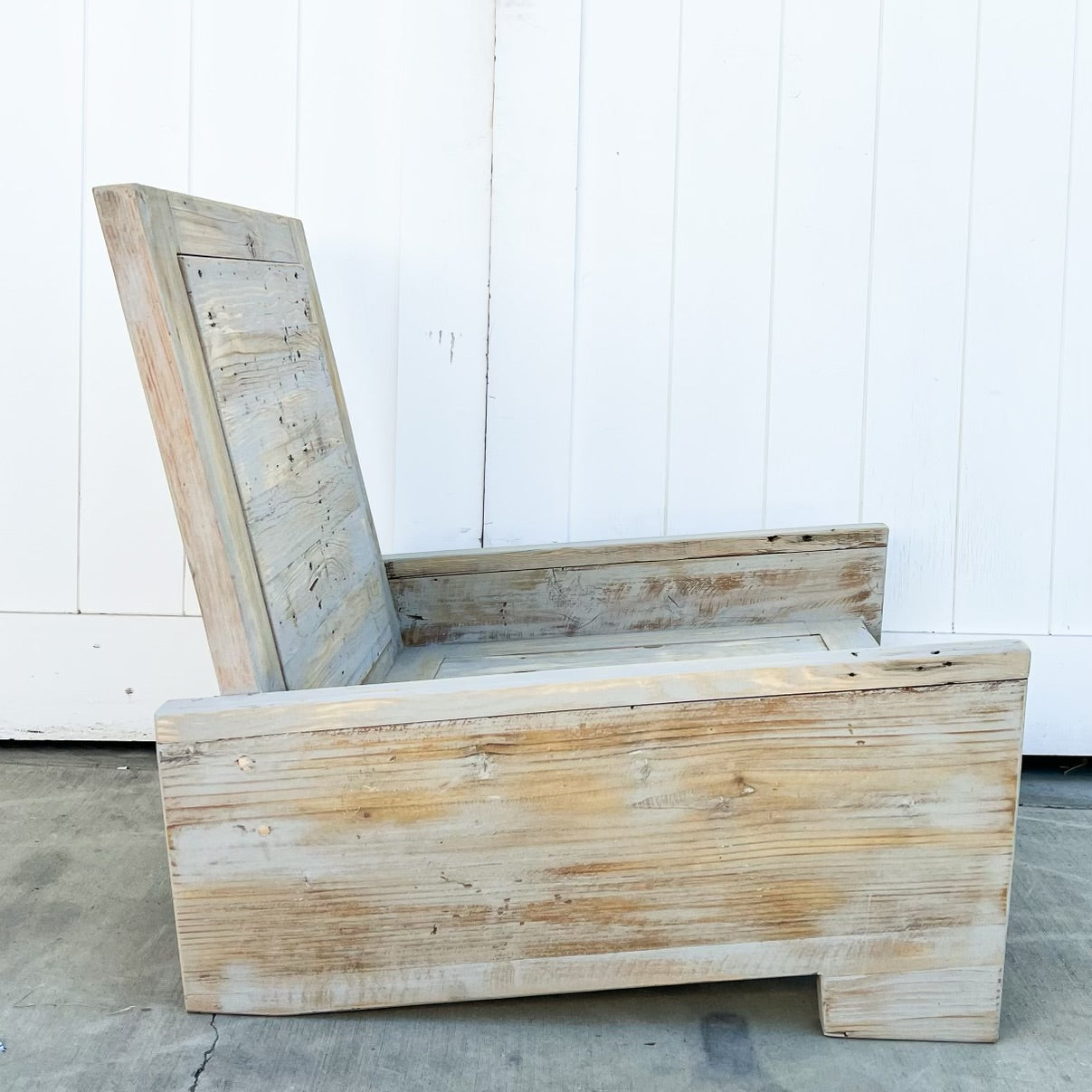 wood outdoor armless lounge chair with white cushions