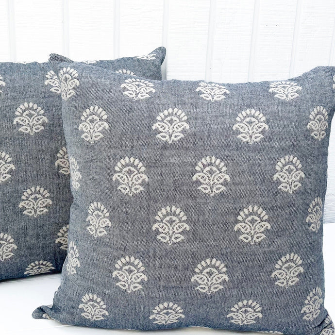 square pillow with pale denim blue-like fabric with white pattern