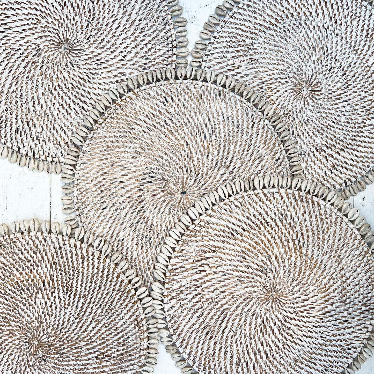 white wash rattan round placemat with off white shell on edge
