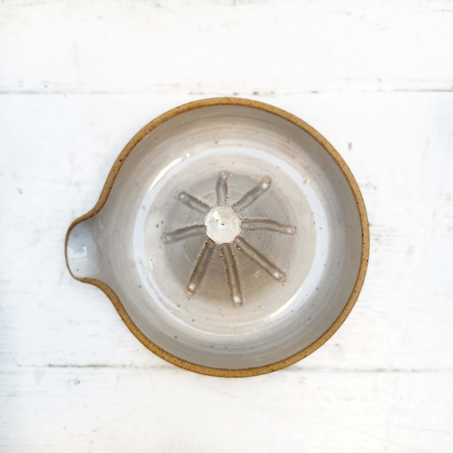 white glazed ceramic hand juicer