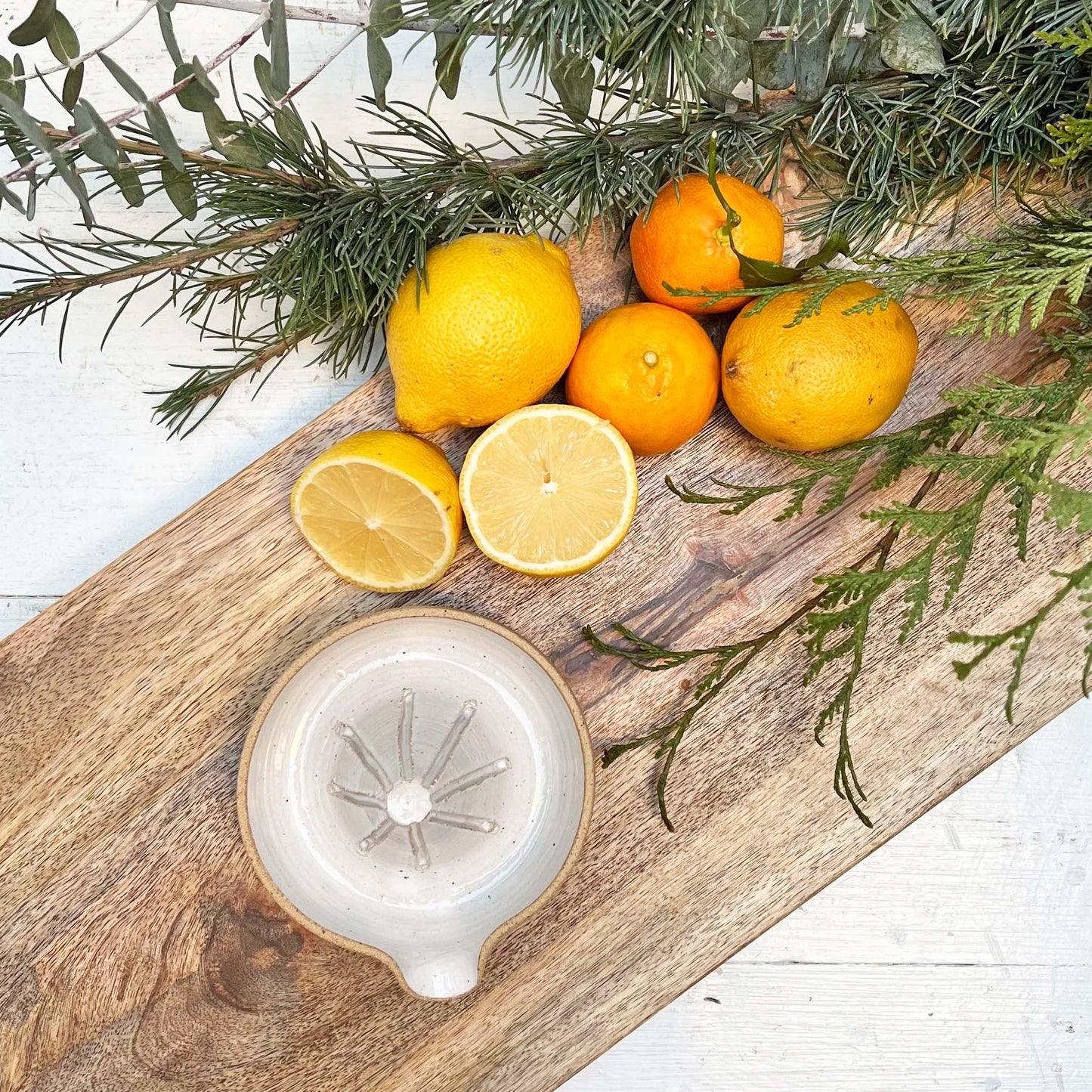 white glazed ceramic hand juicer