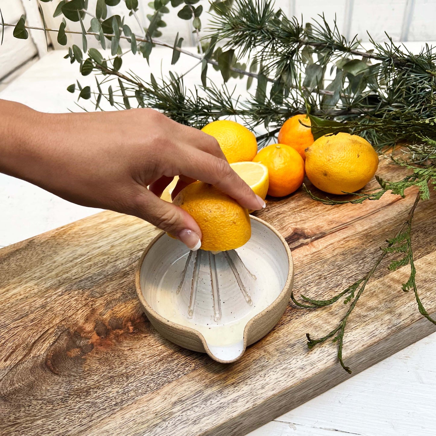 white glazed ceramic hand juicer