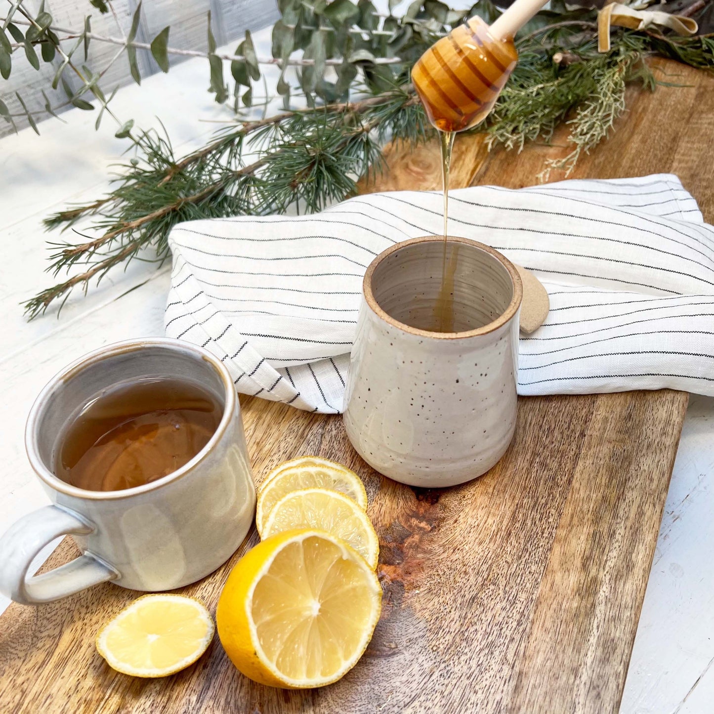 ceramic jar with lid and wooden honey dipper