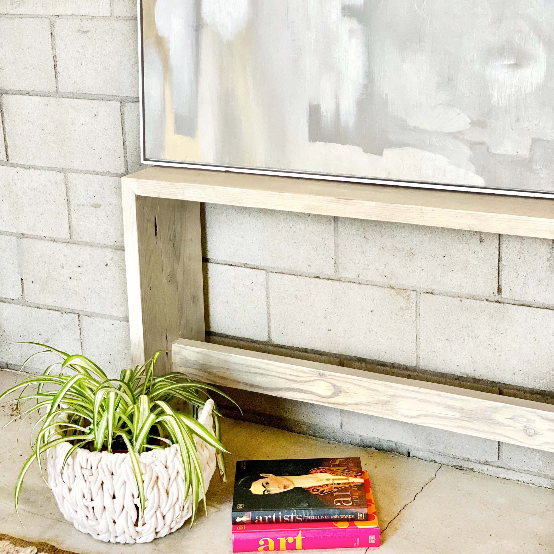 clean line bleached wooden entryway table with bar along bottom