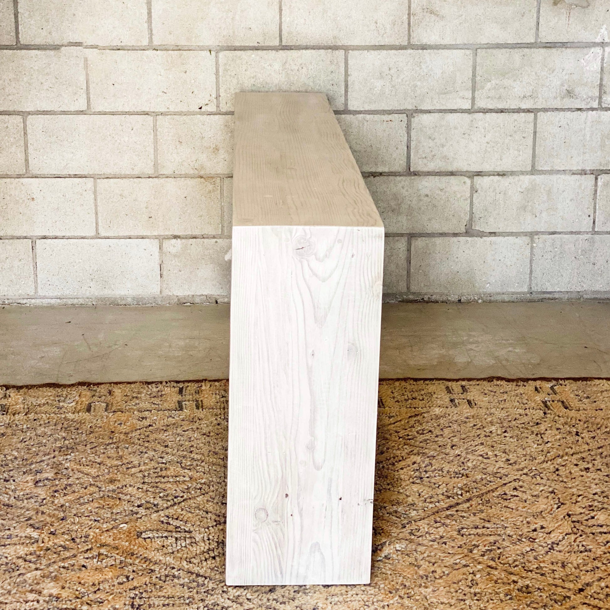 clean line bleached wooden entryway table with bar along bottom