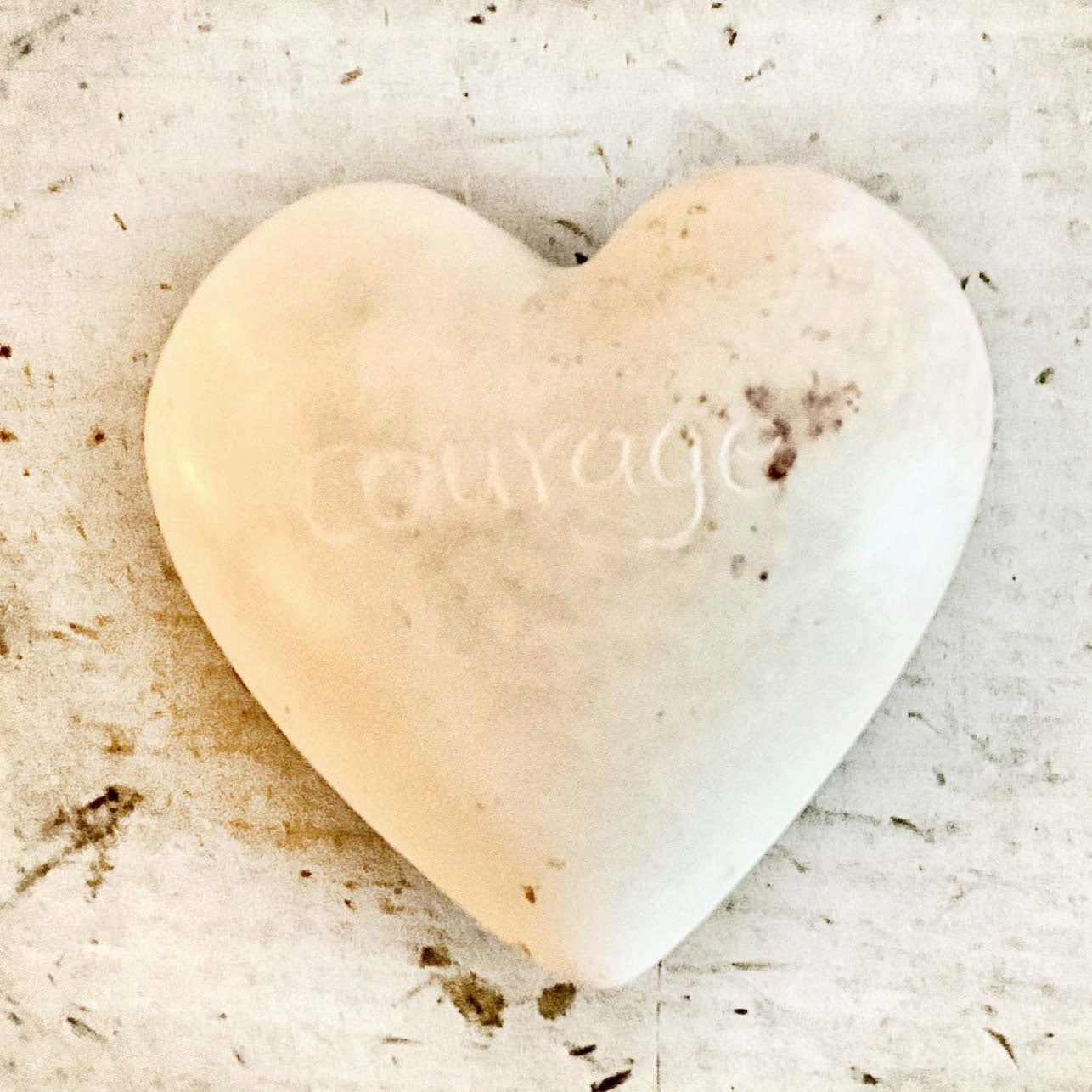 light colored heart shaped stones with inspirational words