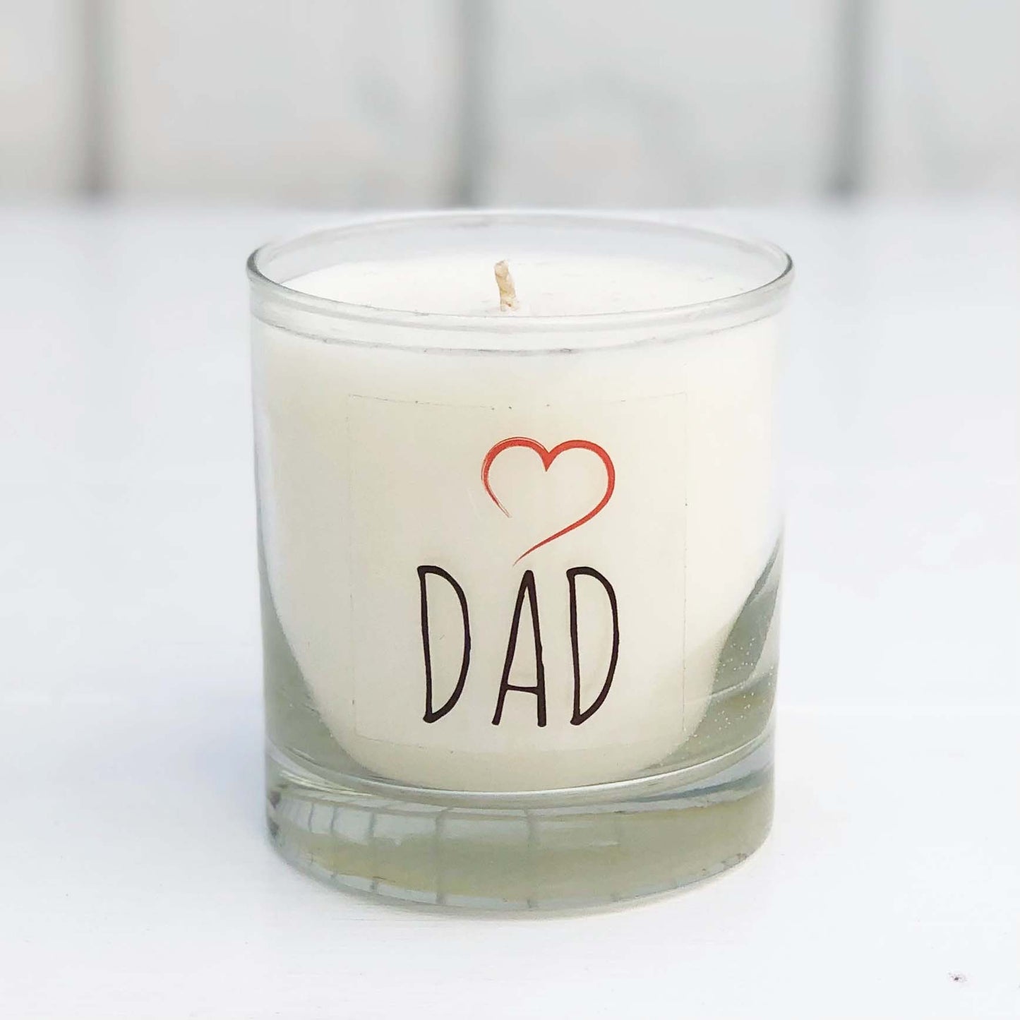fraser fir scented candle in clear glass jar with black letters and red heart