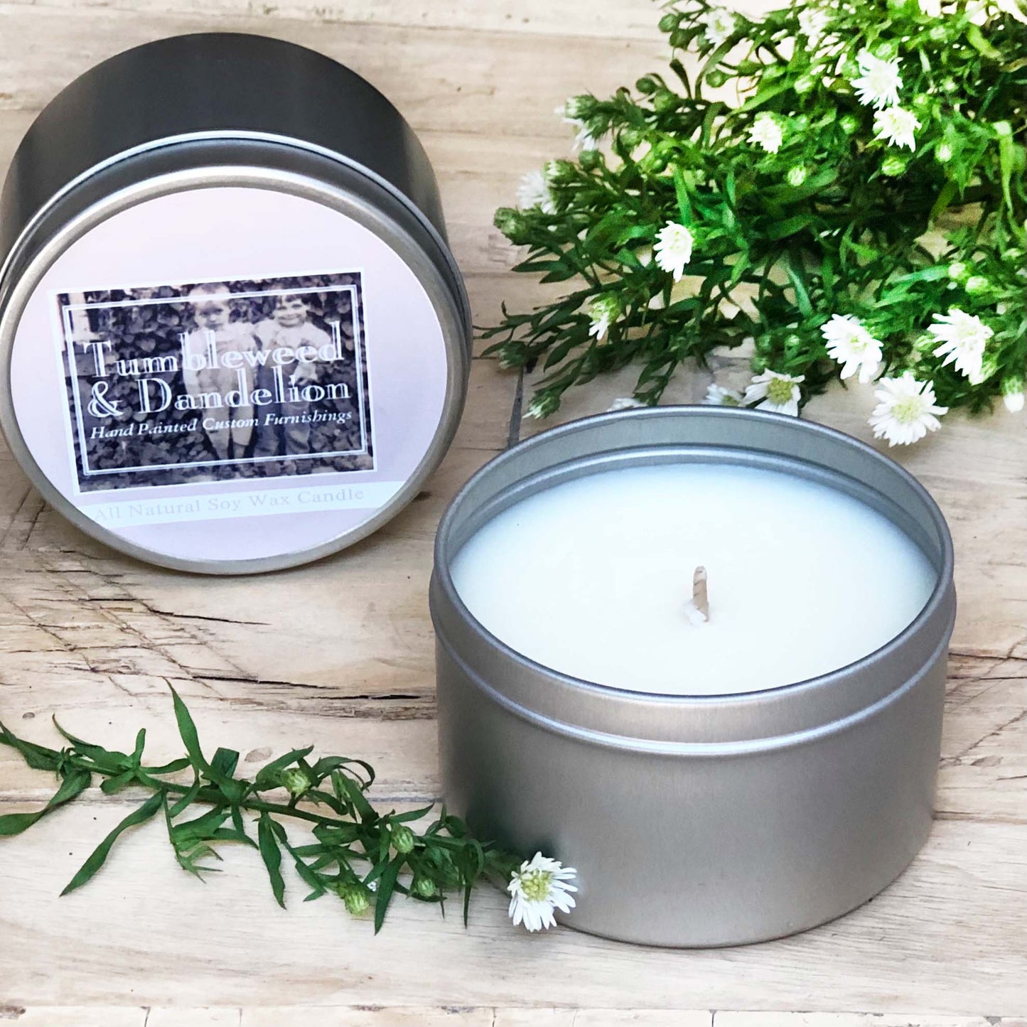 silver tin travel candle with logo on lid