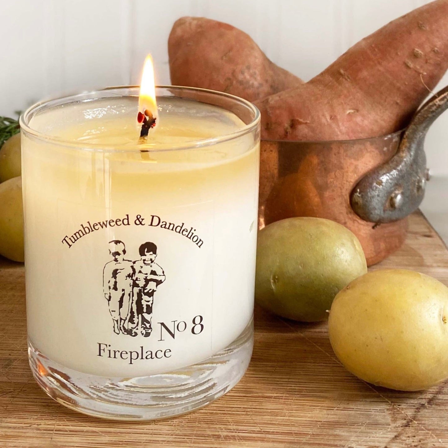 clear glass candle with black Tumbleweed logo, fireplace scent