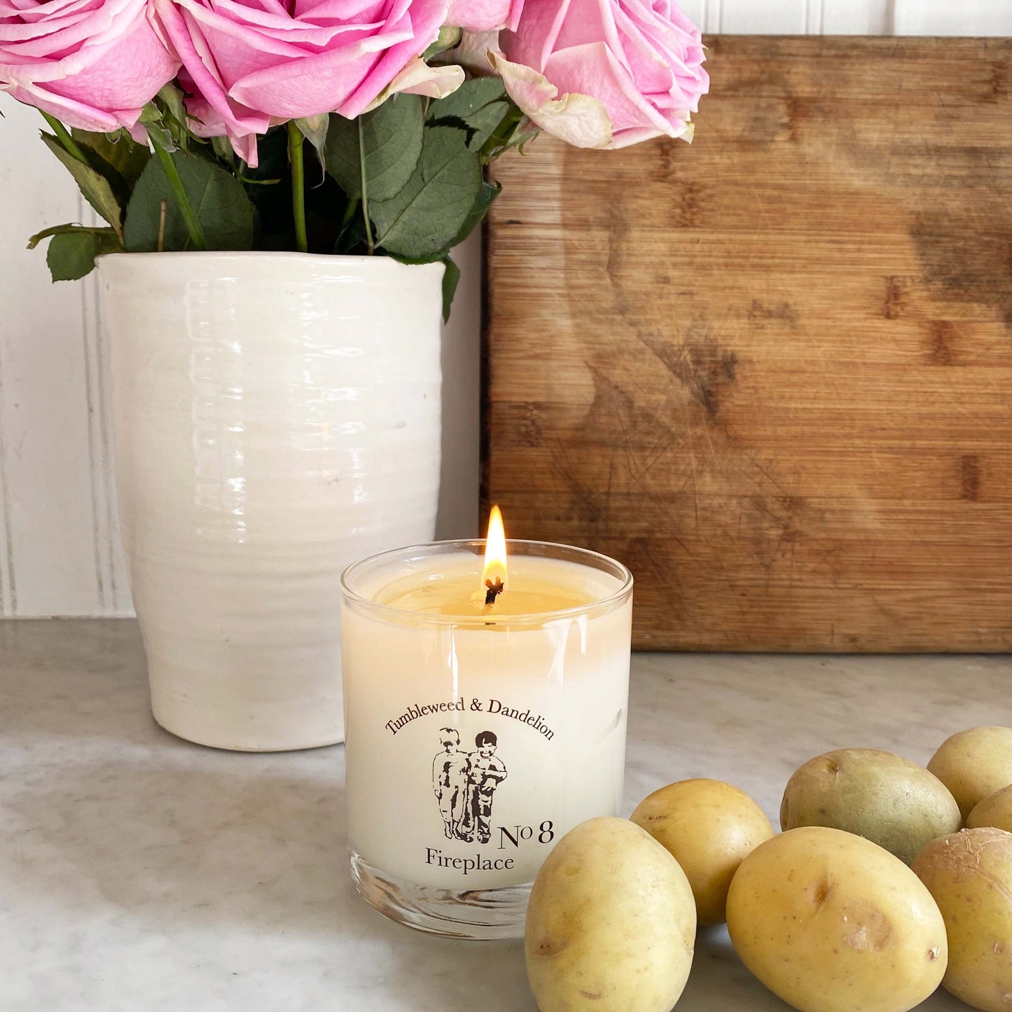 clear glass candle with black Tumbleweed logo, fireplace scent