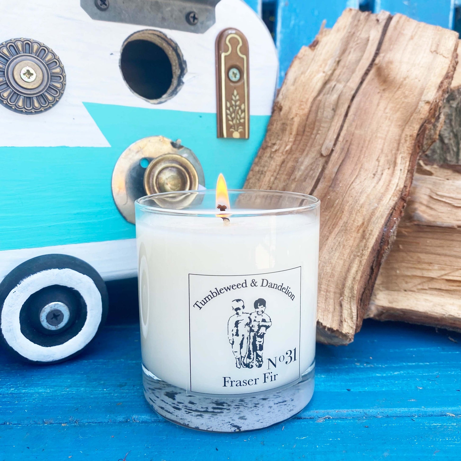 Fraser Fir scented clear glass candle with black logo