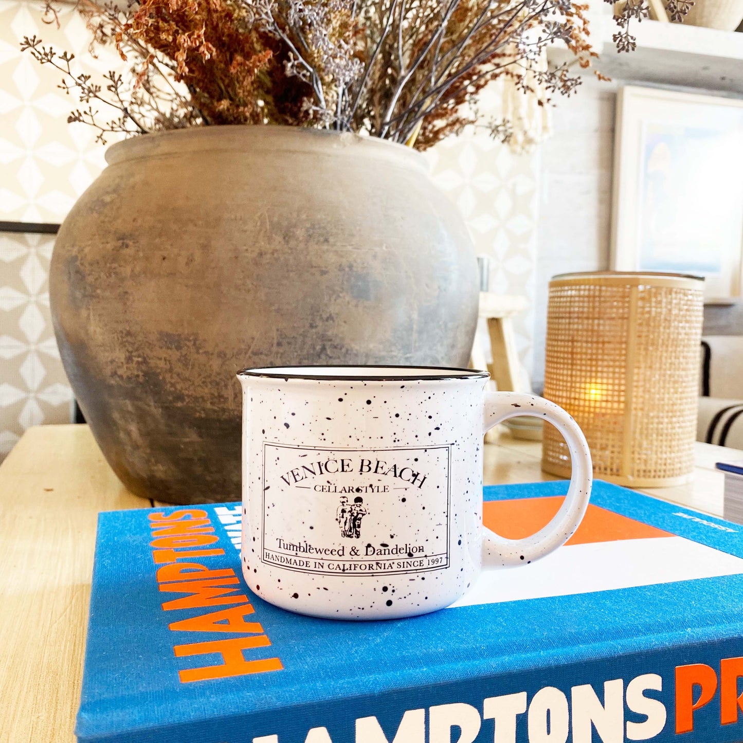 white enamel mug with black speckles and black Tumbleweed logo on front