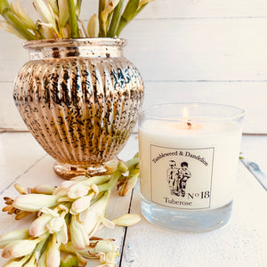 tuberose scented clear glass candle with Tumbleweed and Dandelion logo in black