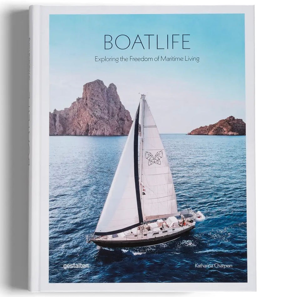 Book cover of 'Boatlife' with a sailboat on the water and mountains in the background