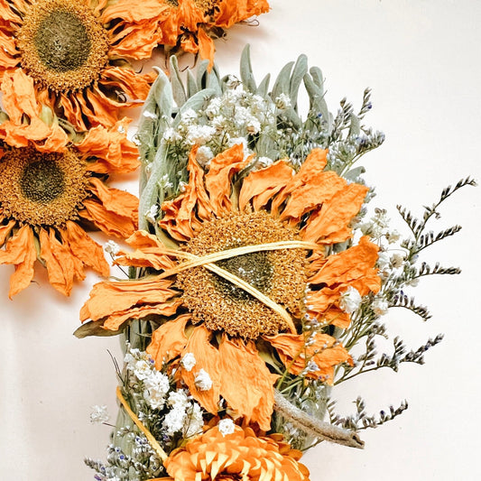 sage smudge stick with dried sunflowers and baby's breath