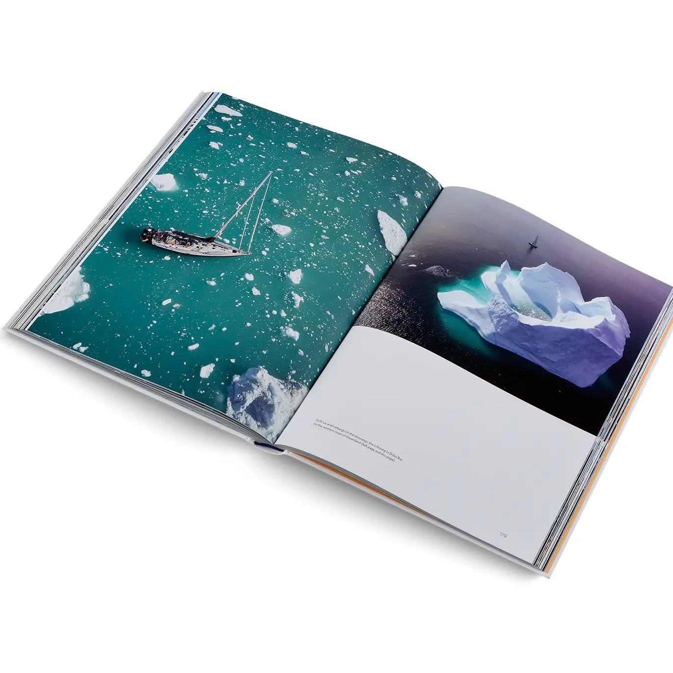 Open book showing images of a sailboat and icebergs on a white background