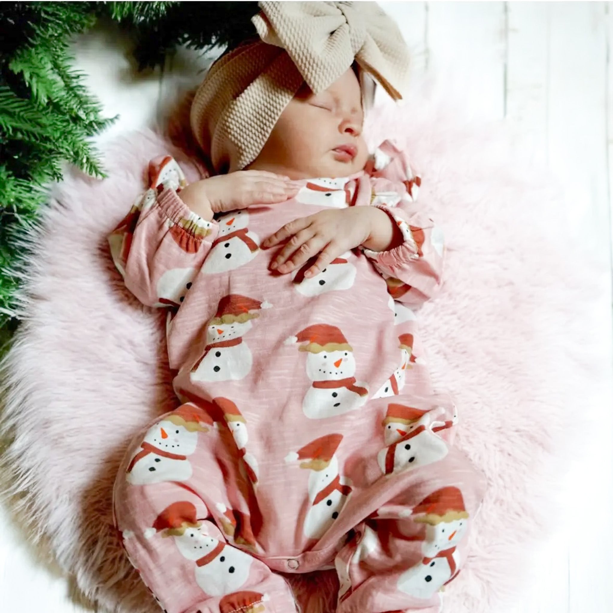 Pink baby pajamas with red and white snowmen