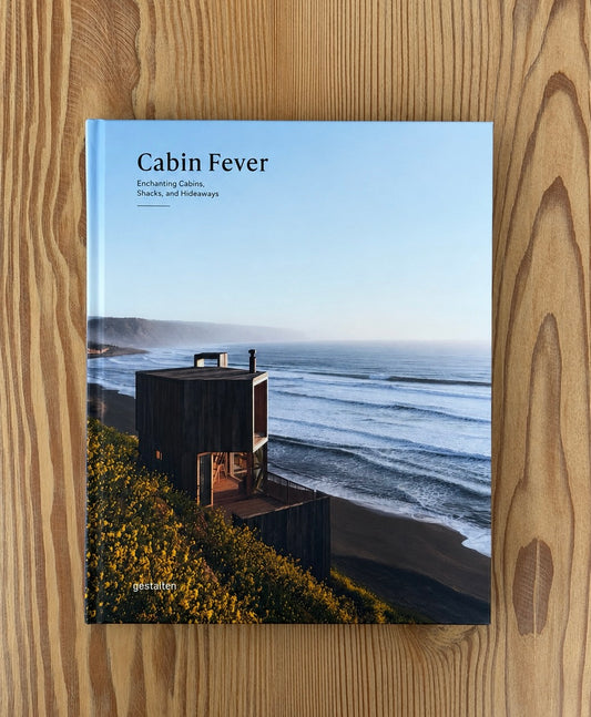 Book titled 'Cabin Fever' on a wooden surface