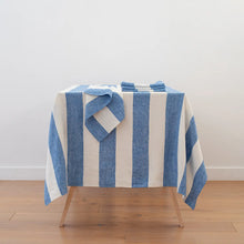 Load image into Gallery viewer, Blue and white striped towel on a wooden stool against a white wall