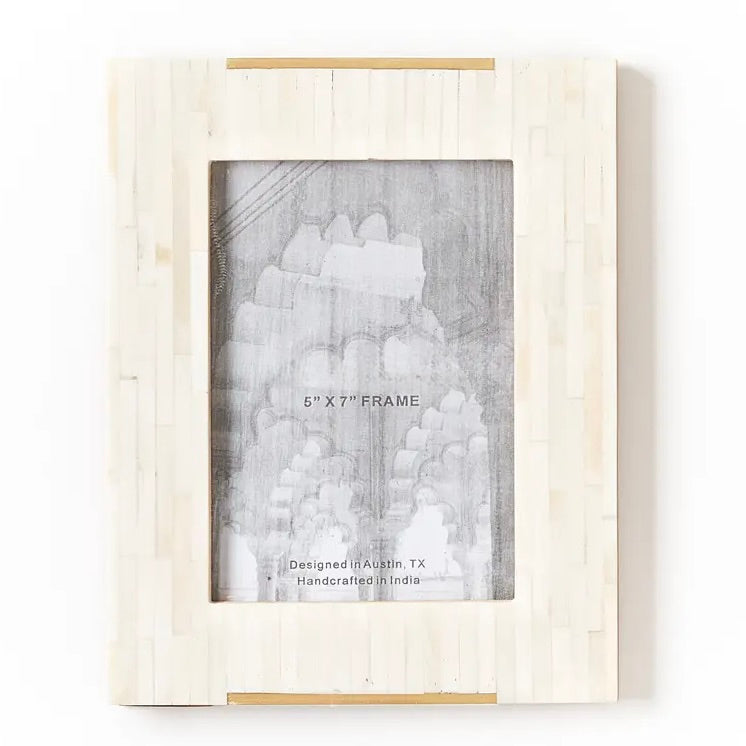 bone inlayed picture frame with brass bar accent along top and bottom