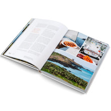 Load image into Gallery viewer, Open book with images of a coastal scene and food on a white background