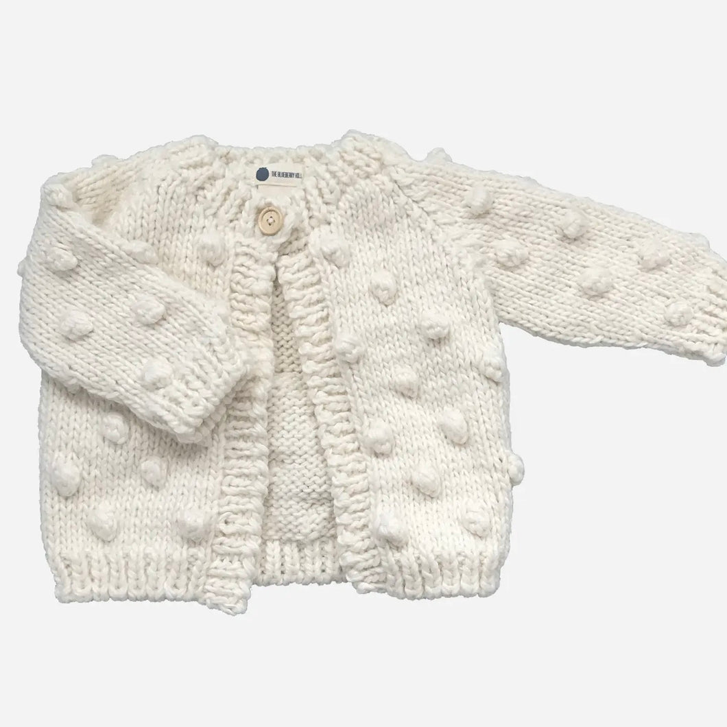 white kid's button down sweater with small nubs