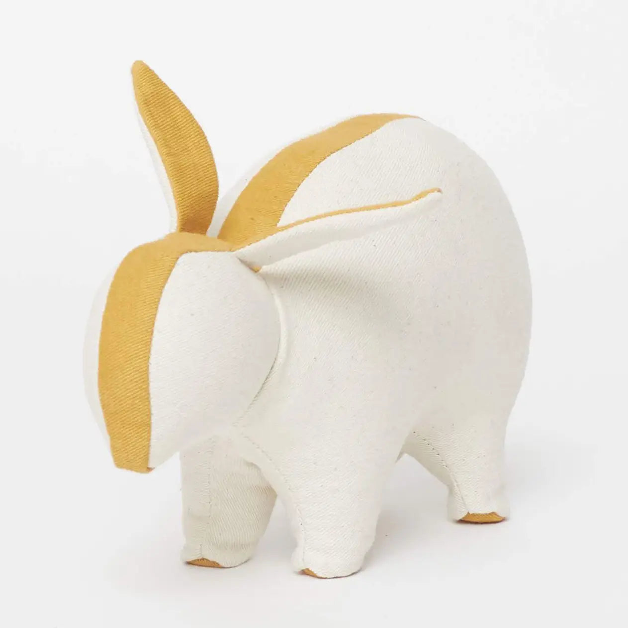 White plush toy with yellow accents on a white background