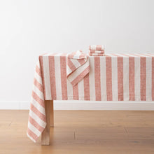 Load image into Gallery viewer, Pink and white striped tablecloth on a wooden table with a white wall background