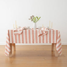 Load image into Gallery viewer, Table with a pink and white striped tablecloth on a wooden floor.
