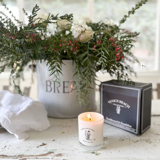 white glass candle with dark gray candle box with Tumbleweed logo