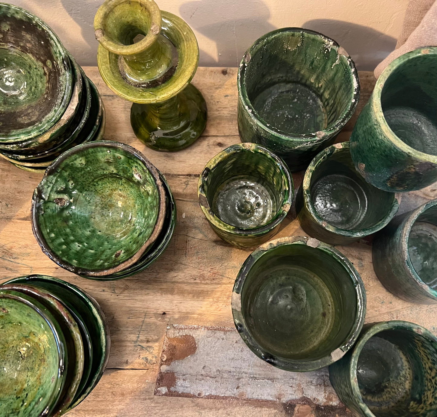 rustic ceramic handmade bowl in varying shapes and sizes with green glaze